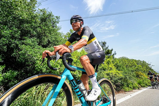 Close-up of a cyclist racing through the lush landscapes of Bursa, Türkiye with focus on knee - vastus medialis